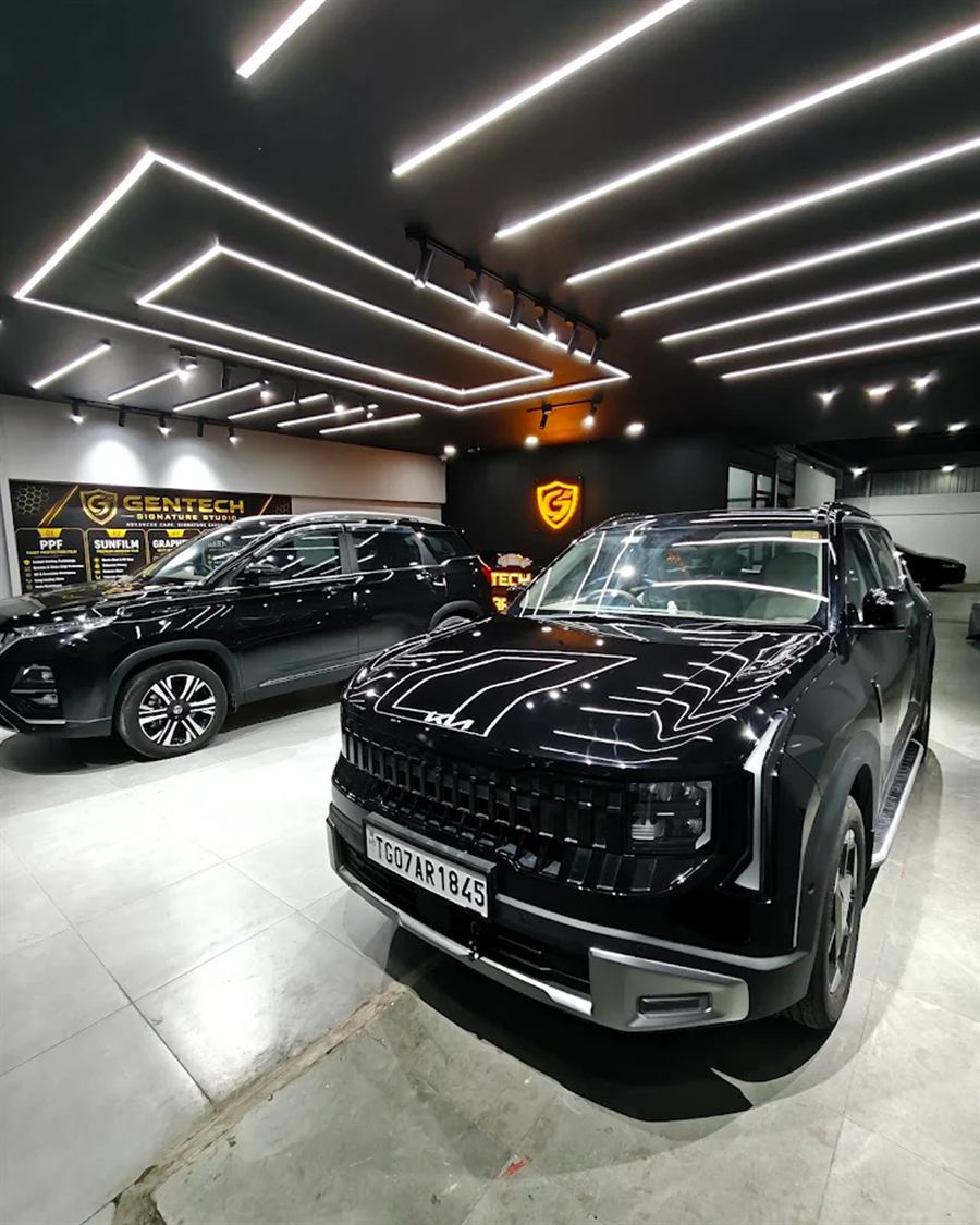 Inside Gentech Signature Studio: freshly detailed black SUVs under studio lighting