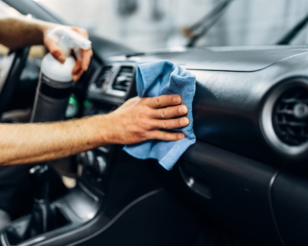 Aftercare wipe-down of a car's interior with microfiber
