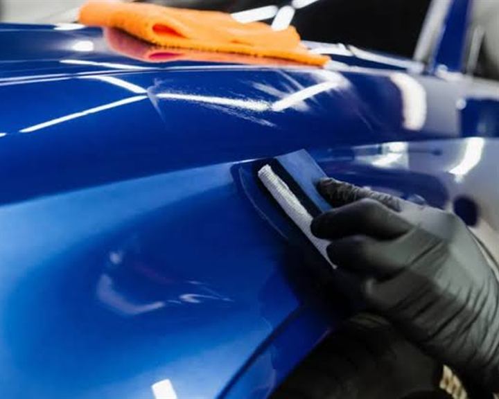 Ceramic coating applied to a deep blue bonnet with an applicator pad