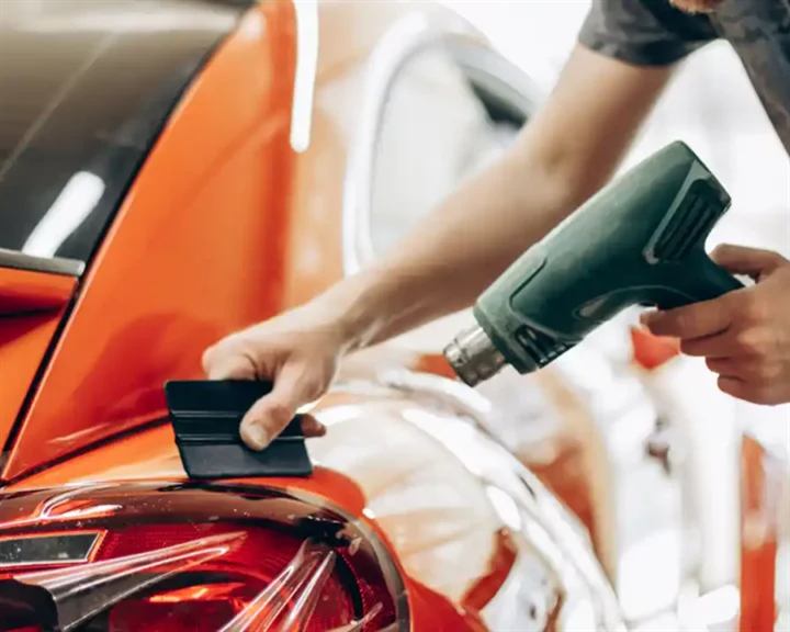 Self-healing PPF applied to a car's rear panel with squeegee and heat gun